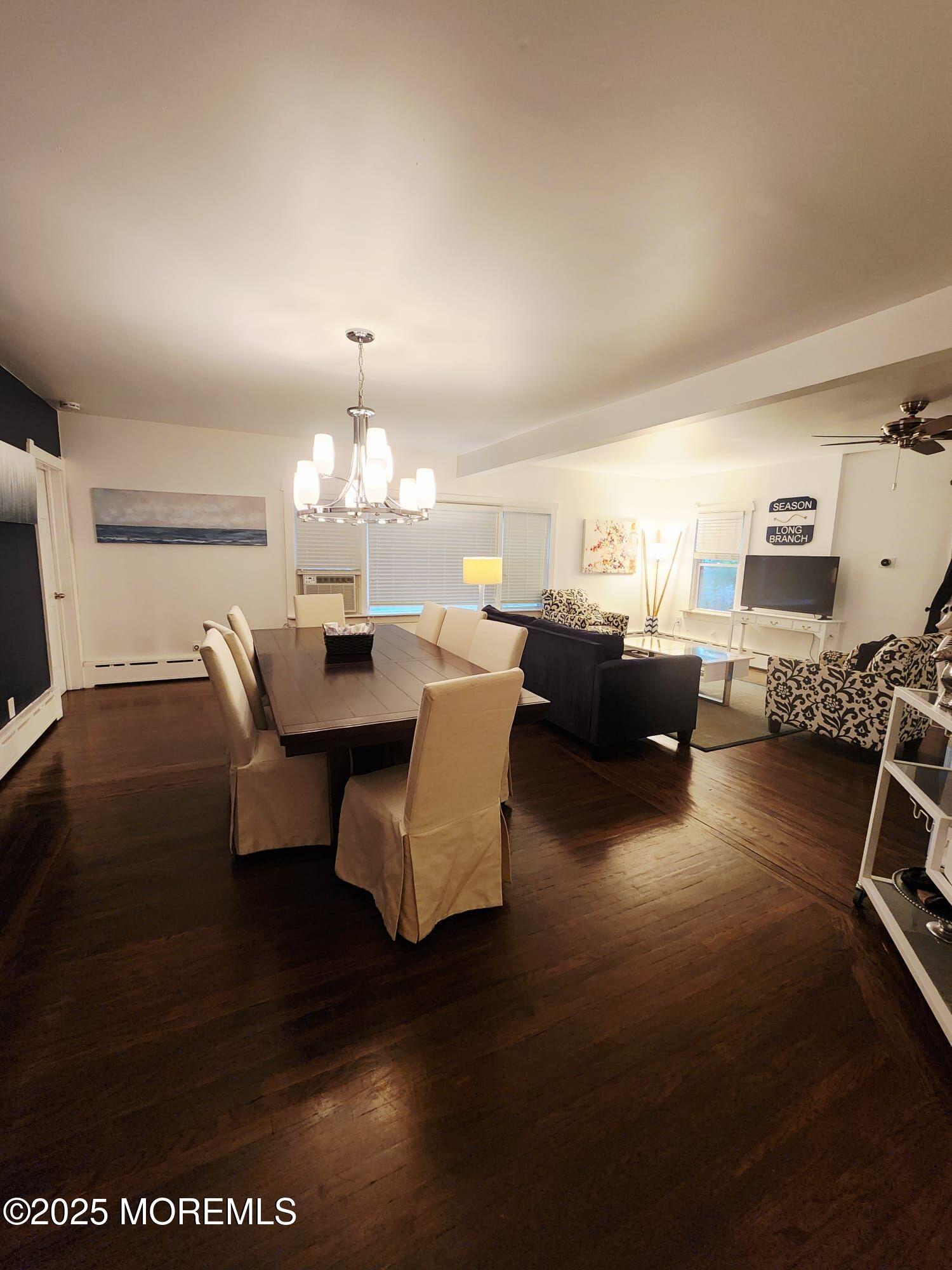 393 Bath Avenue Long Branch, NJ 07740 - Photo 20 of 22 a living room with furniture a dining table and a fireplace