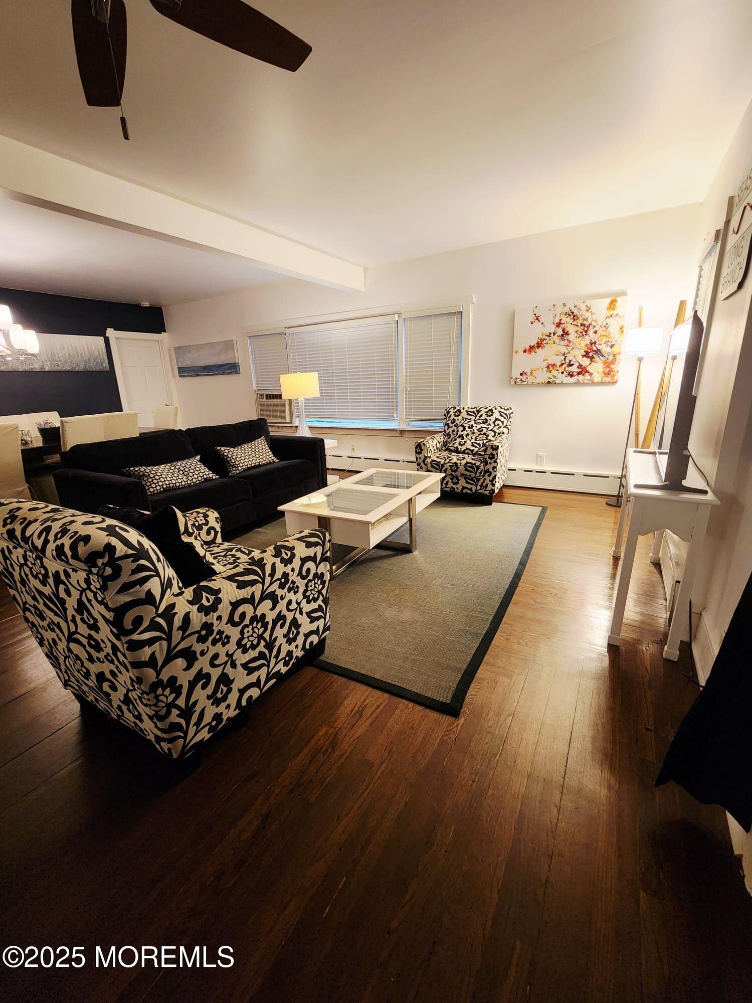 393 Bath Avenue Long Branch, NJ 07740 - Photo 21 of 22 a living room with furniture and a flat screen tv