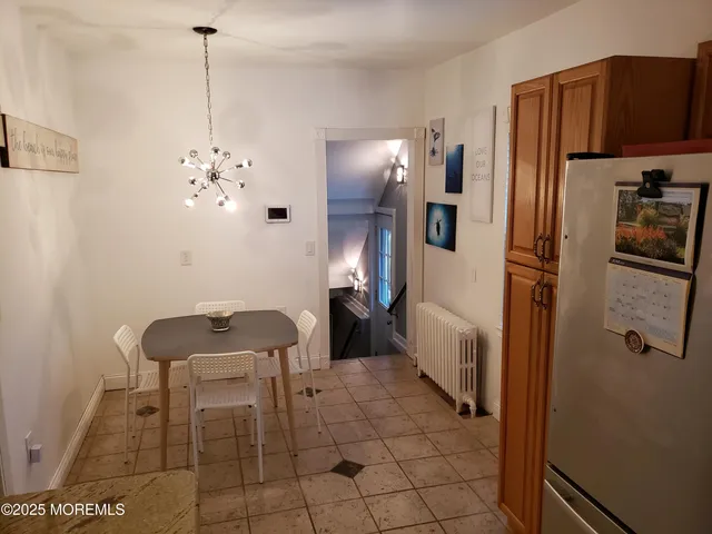 a bathroom with a sink and a refrigerator