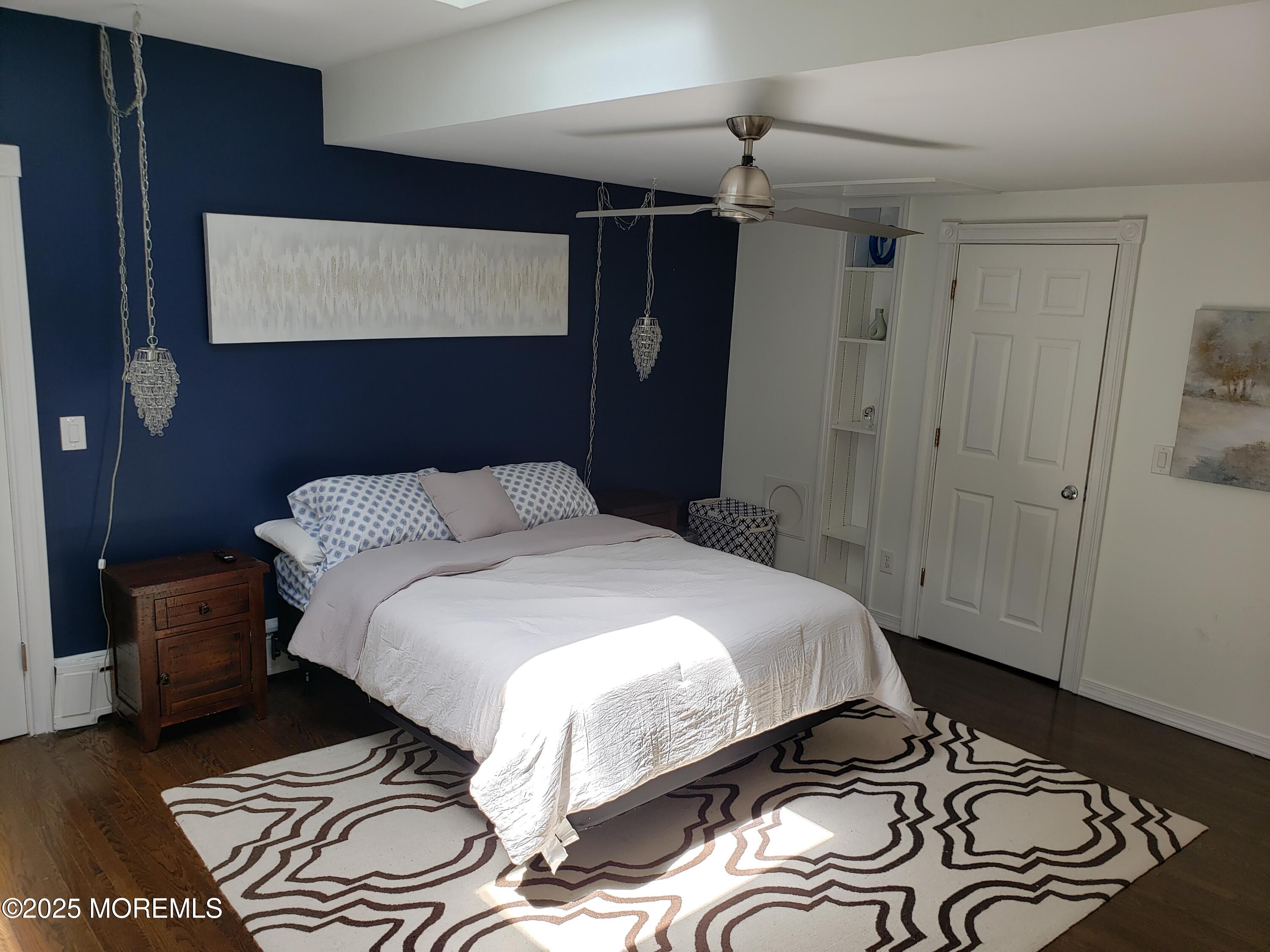 393 Bath Avenue Long Branch, NJ 07740 - Photo 4 of 22 a bedroom with a bed and a mirror