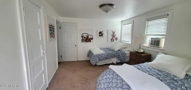 a bedroom with two beds and a window