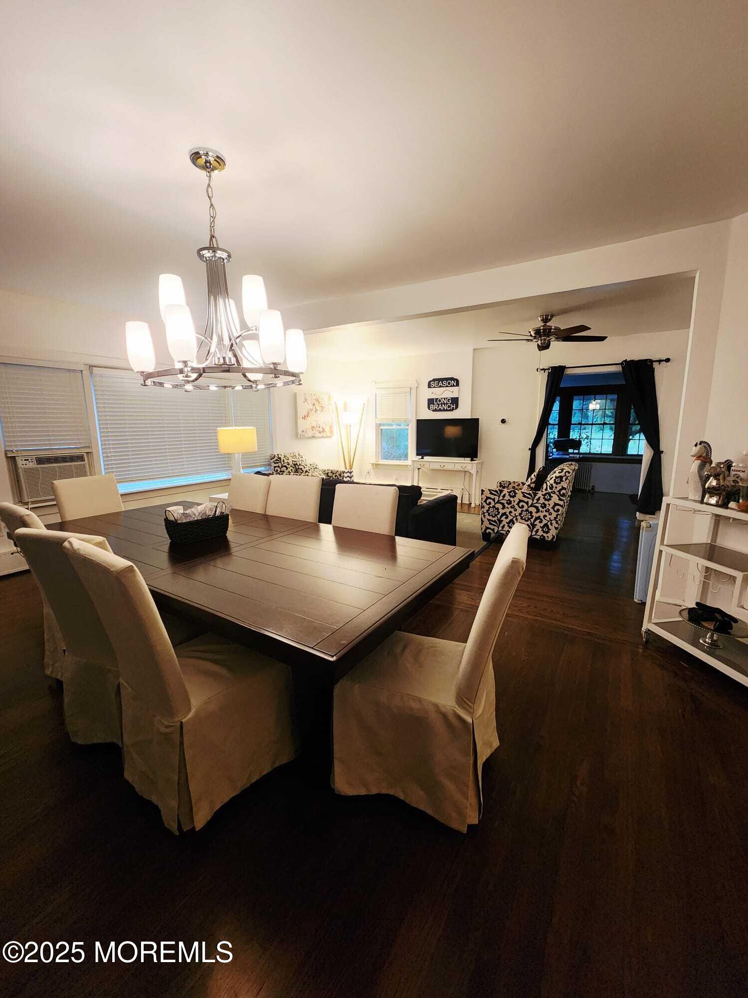 393 Bath Avenue Long Branch, NJ 07740 - Photo 8 of 22 a living room with furniture a chandelier and a dining table