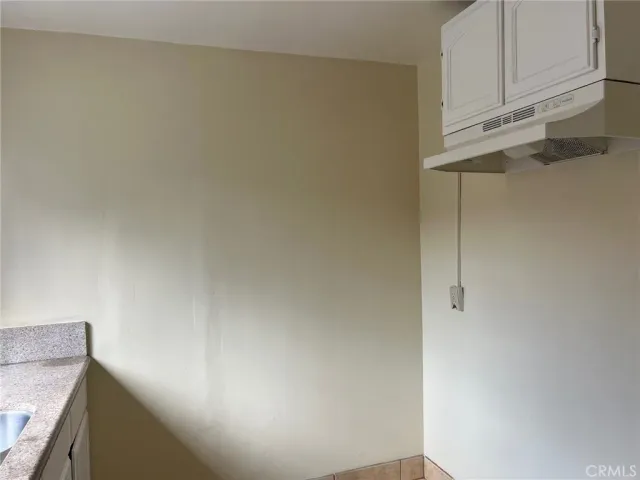 a view of storage and utility room with cabinets