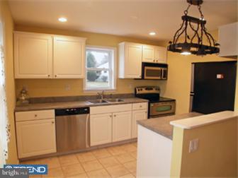 114 Midland Road Newtown, PA 18940 - Photo 4 of 12 a kitchen with stainless steel appliances granite countertop a stove a sink and a microwave