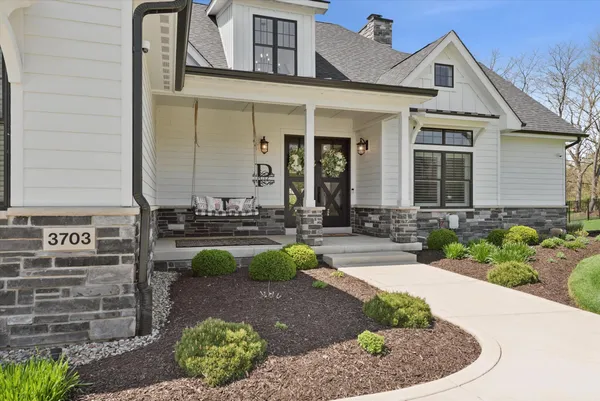 a front view of a house with garden