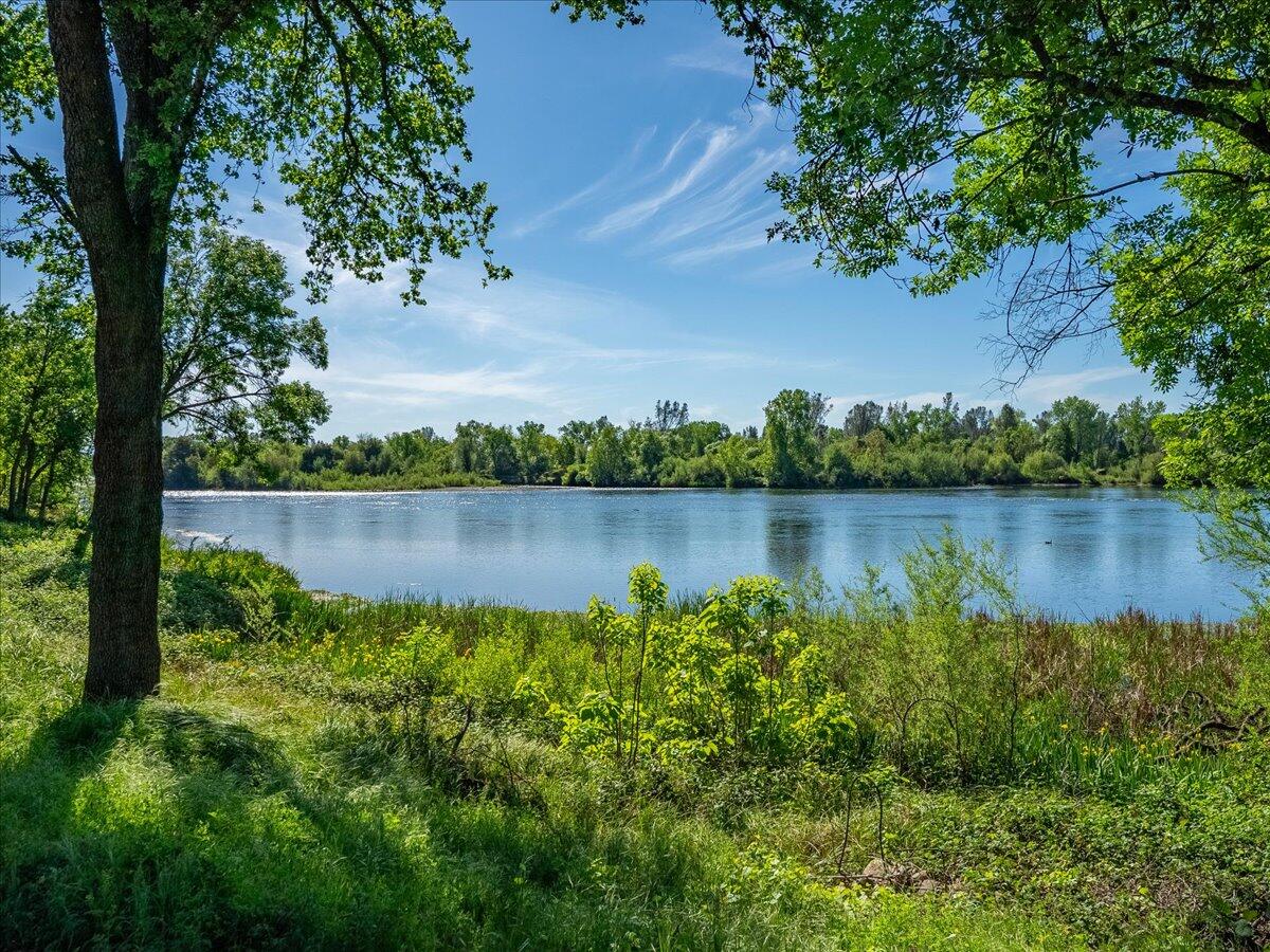 19301 Clover Road Redding, CA 96002 - Photo 11 of 18 a view of a lake with a house in the background