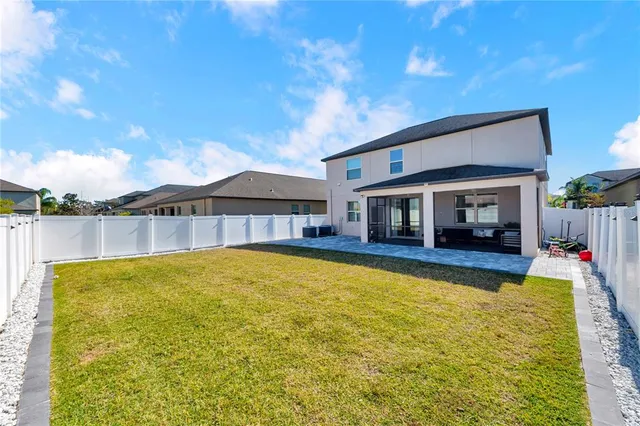 a view of a house with swimming pool and a yard