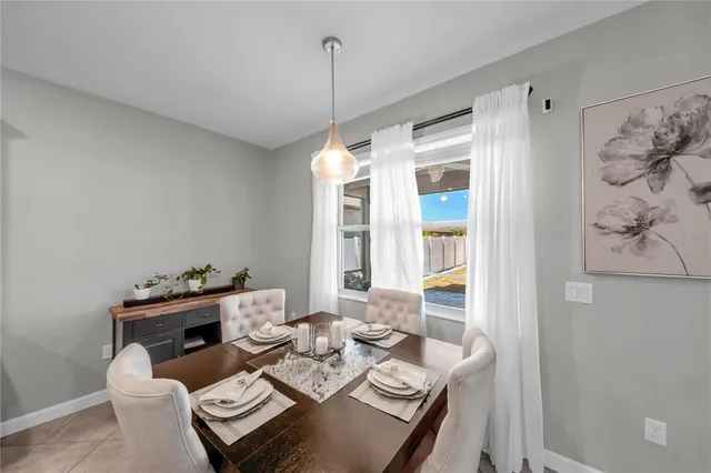 a dining room with furniture a chandelier and window