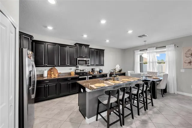 a kitchen with granite countertop lots of counter top space and stainless steel appliances