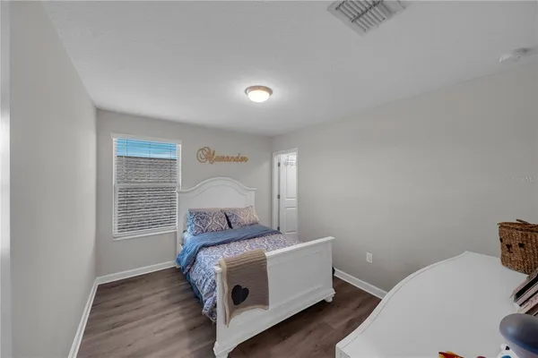 a bed room with a bed and a window