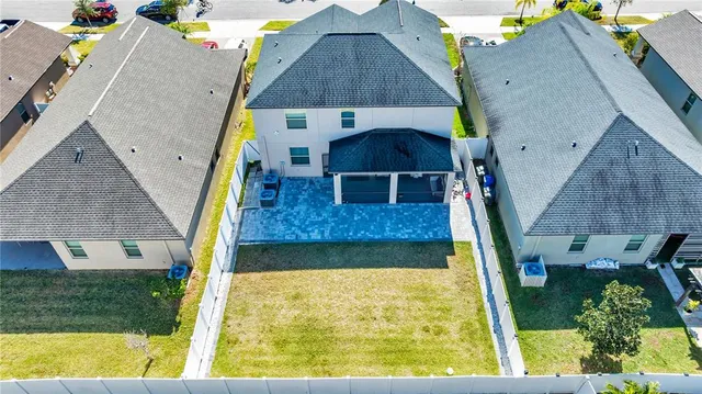 an aerial view of a house with a yard