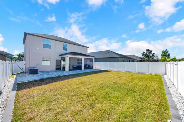 a view of an house with swimming pool and sitting area