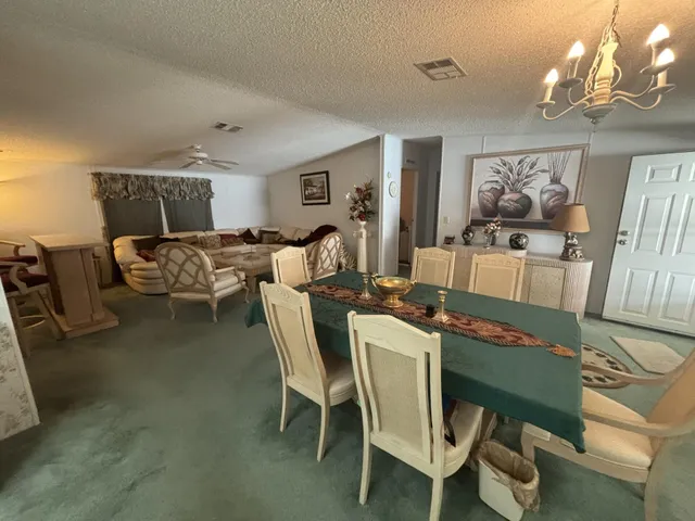 a living room with furniture and chandelier