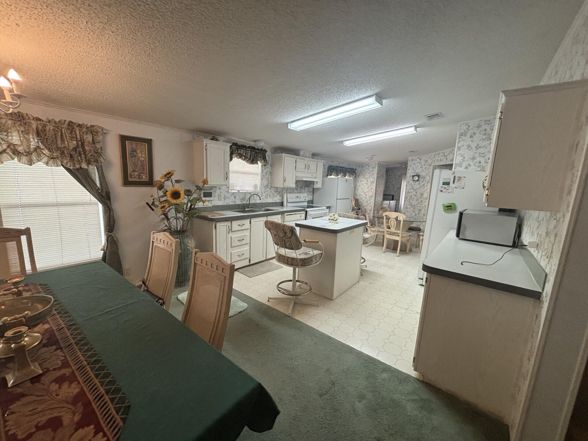 13281 Southwest 10th Manor Davie, FL 33325 - Photo 13 of 43 a living room with lots of white furniture and a table