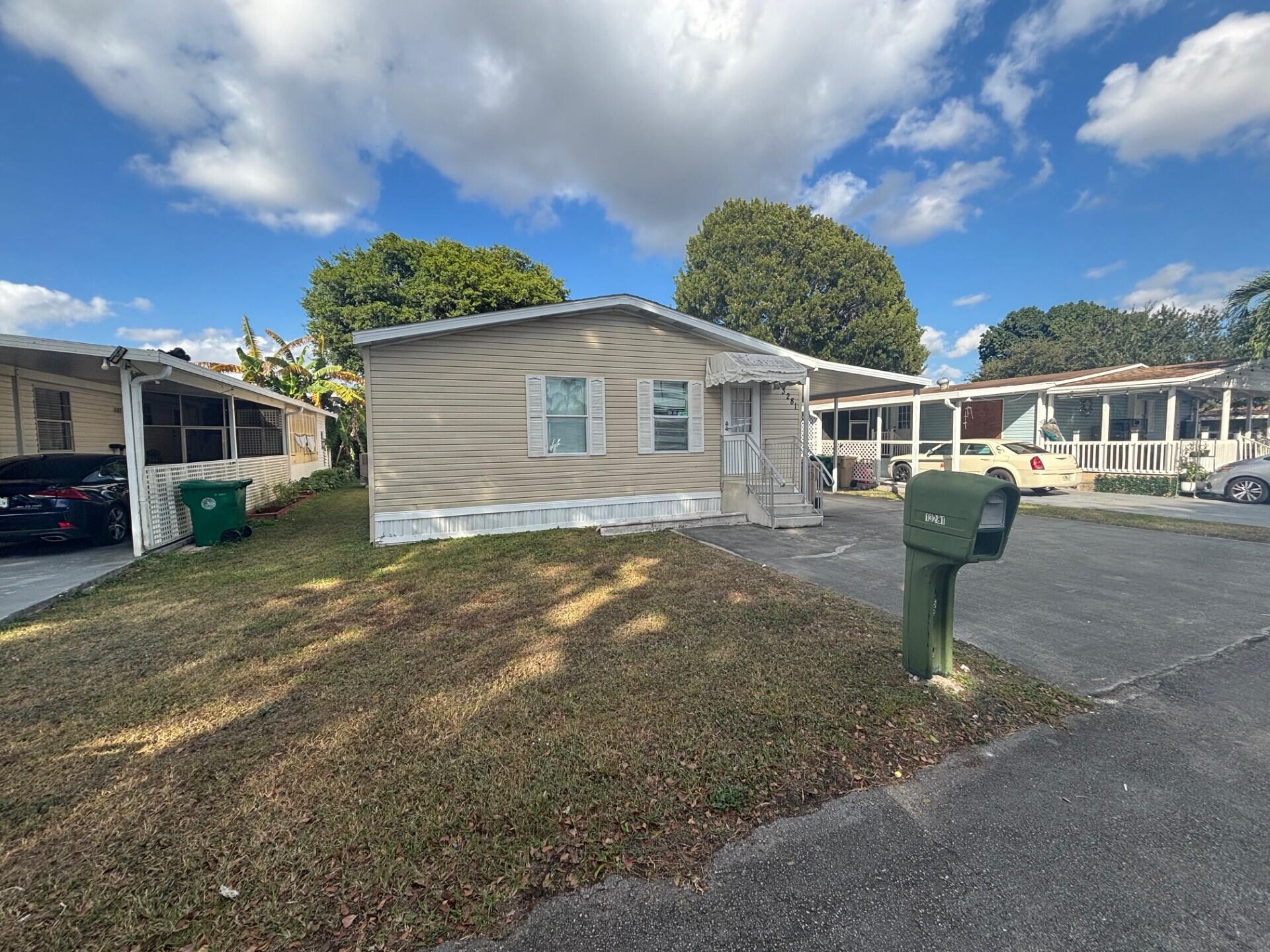 13281 Southwest 10th Manor Davie, FL 33325 - Photo 2 of 43 a front view of a house with a yard and potted plants