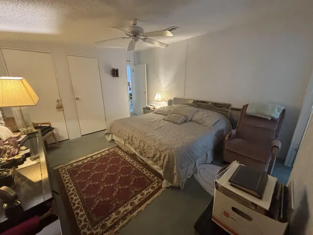 a bedroom with a bed and a lamp