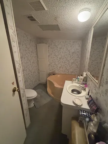 a bathroom with a toilet sink and shower curtain