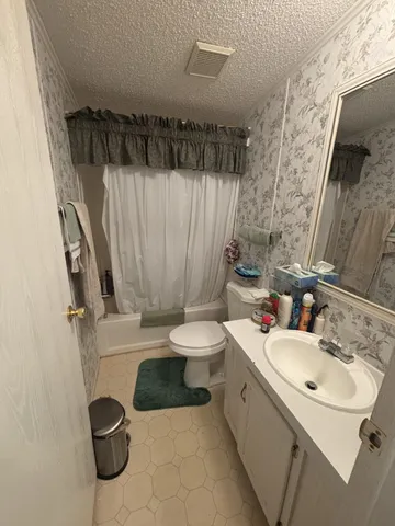 a bedroom with a bed and a desk