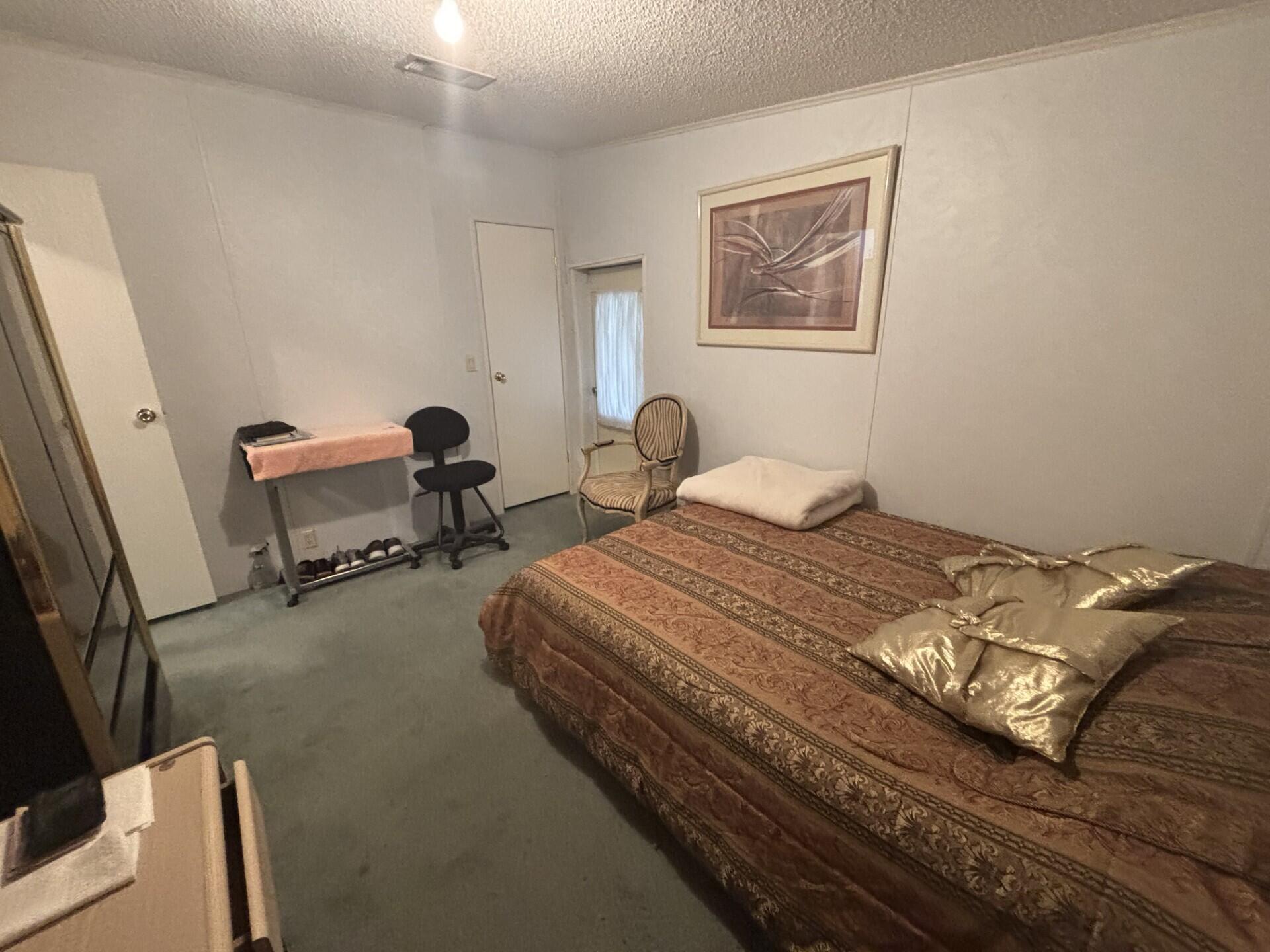 13281 Southwest 10th Manor Davie, FL 33325 - Photo 35 of 43 a bedroom with a bed and a desk