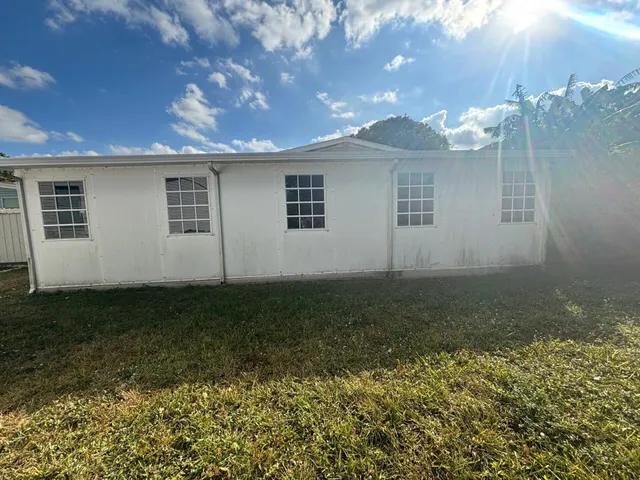 a view of a backyard with plants and a backyard