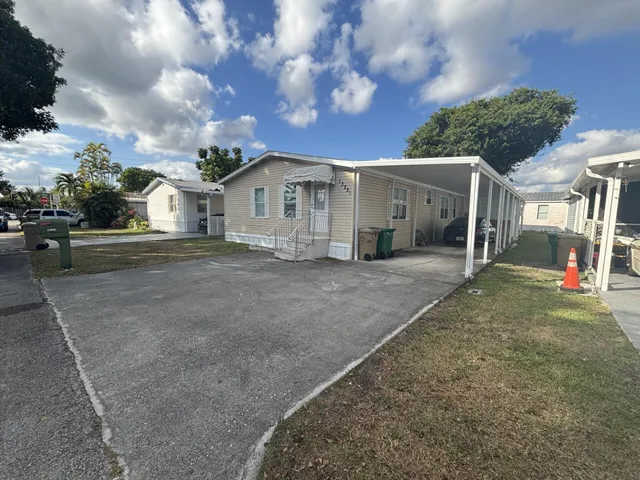 a view of a house with a yard and garage