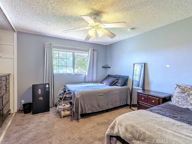 a bedroom with two beds and a chandelier