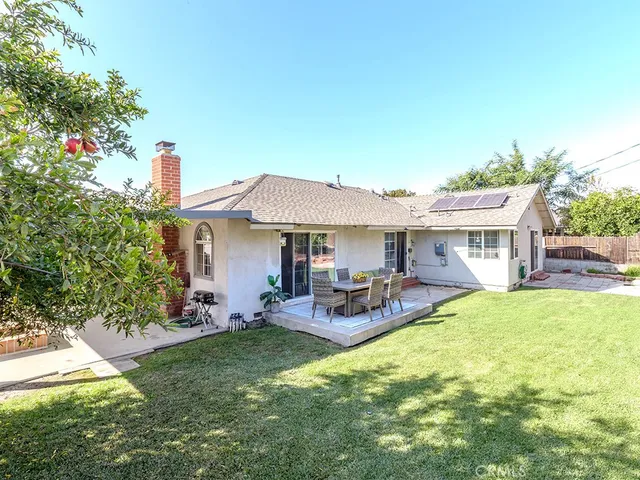 a view of a house with patio and a garden