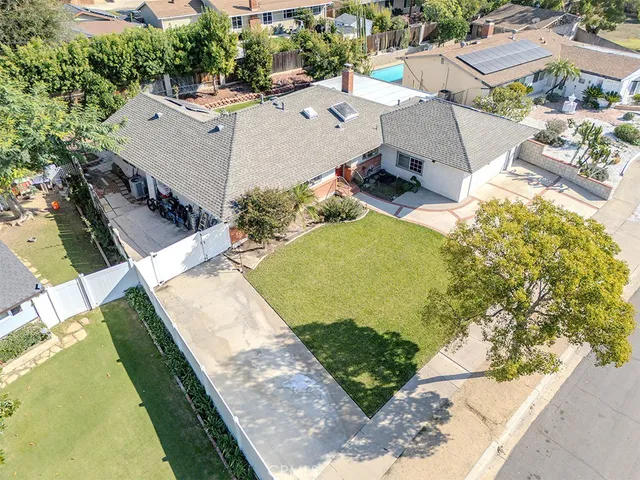 an aerial view of a house with a yard and lake view
