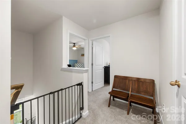 a view of a room with furniture and a mirror