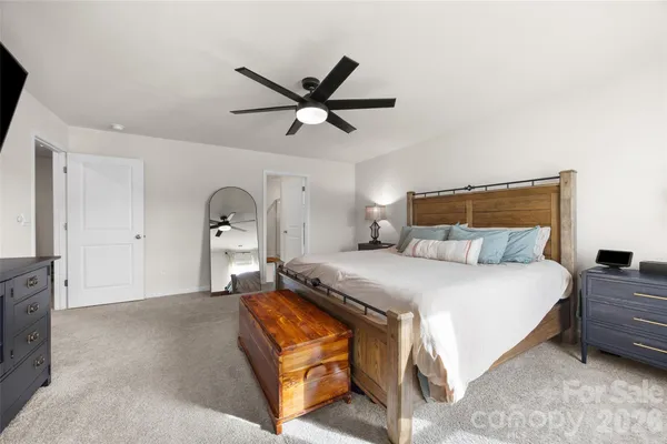 a bedroom with a bed dresser and a window