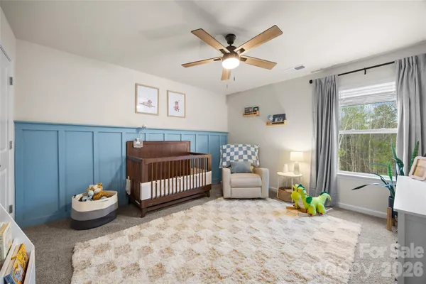 a bedroom with furniture and a window