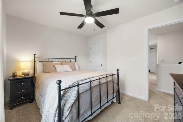 a bedroom with a bed and a ceiling fan