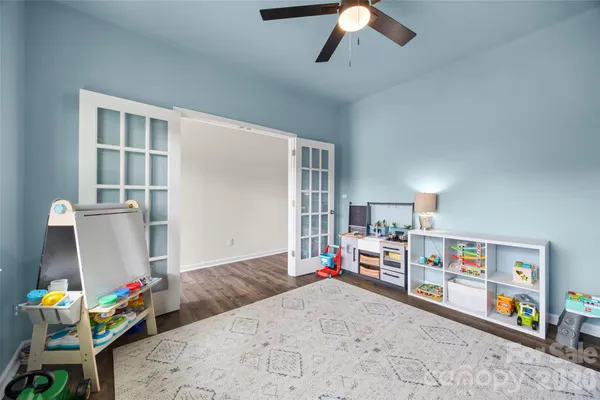 a bedroom with furniture a flat screen tv and a bed