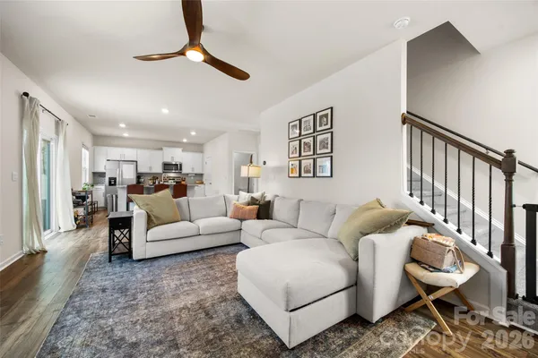 a living room with furniture ceiling fan and a rug