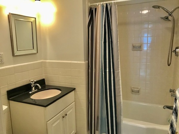 5 Porter Road, Unit 301 Andover, MA 01810 - Photo 24 of 25 a bathroom with a granite countertop sink and a mirror