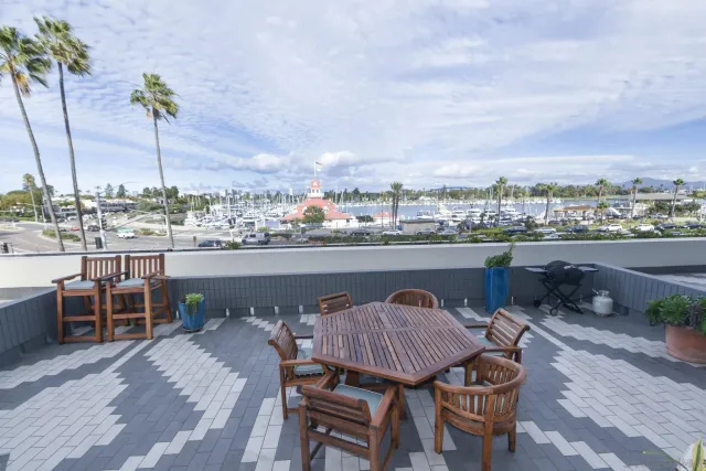 a view of a roof deck with table and chairs