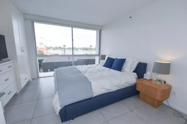 a bed room with a bed and a large window