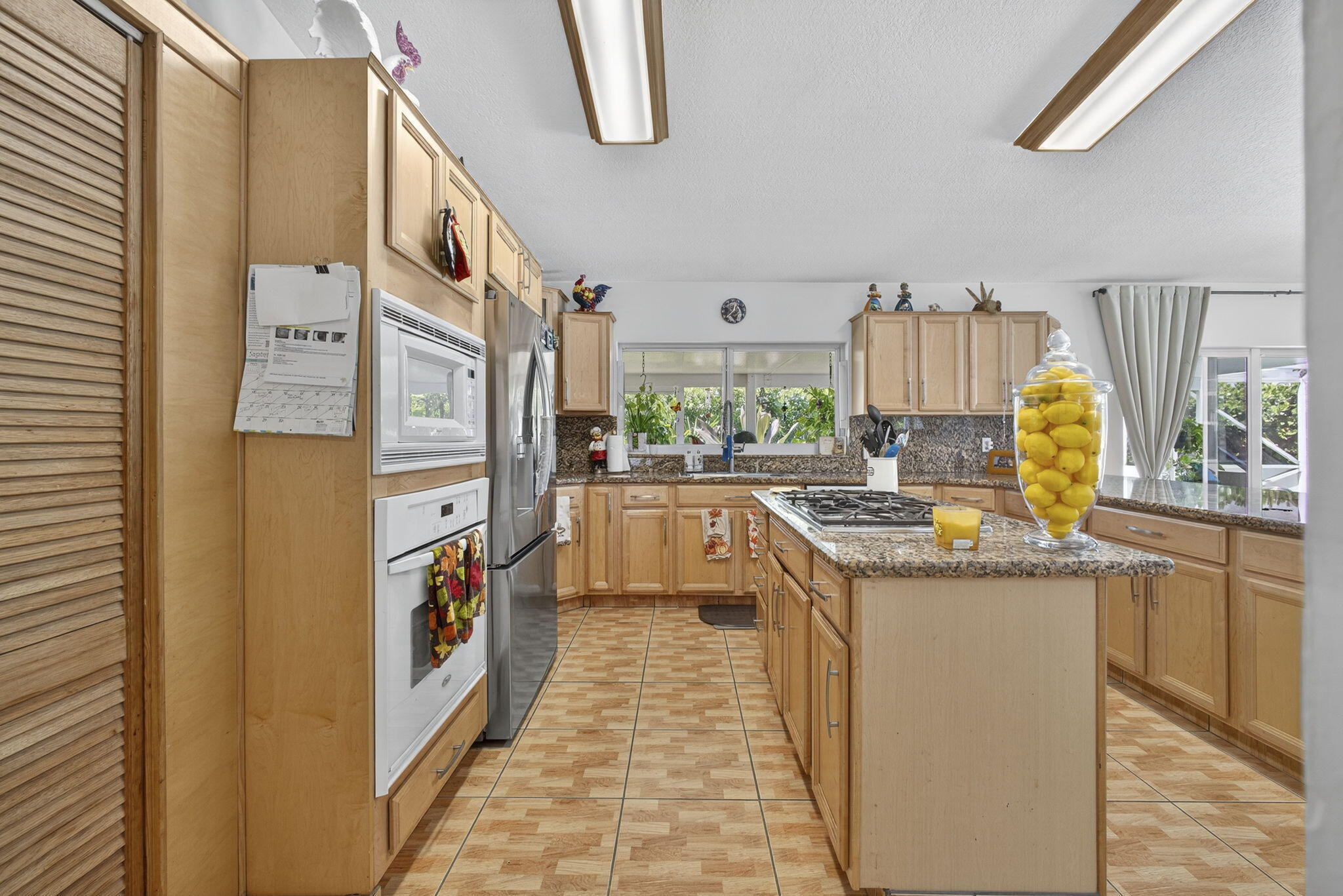 7625 Clarke Road Lake Clarke Shores, FL 33406 - Photo 26 of 97 a kitchen with stainless steel appliances granite countertop a stove a sink and a refrigerator