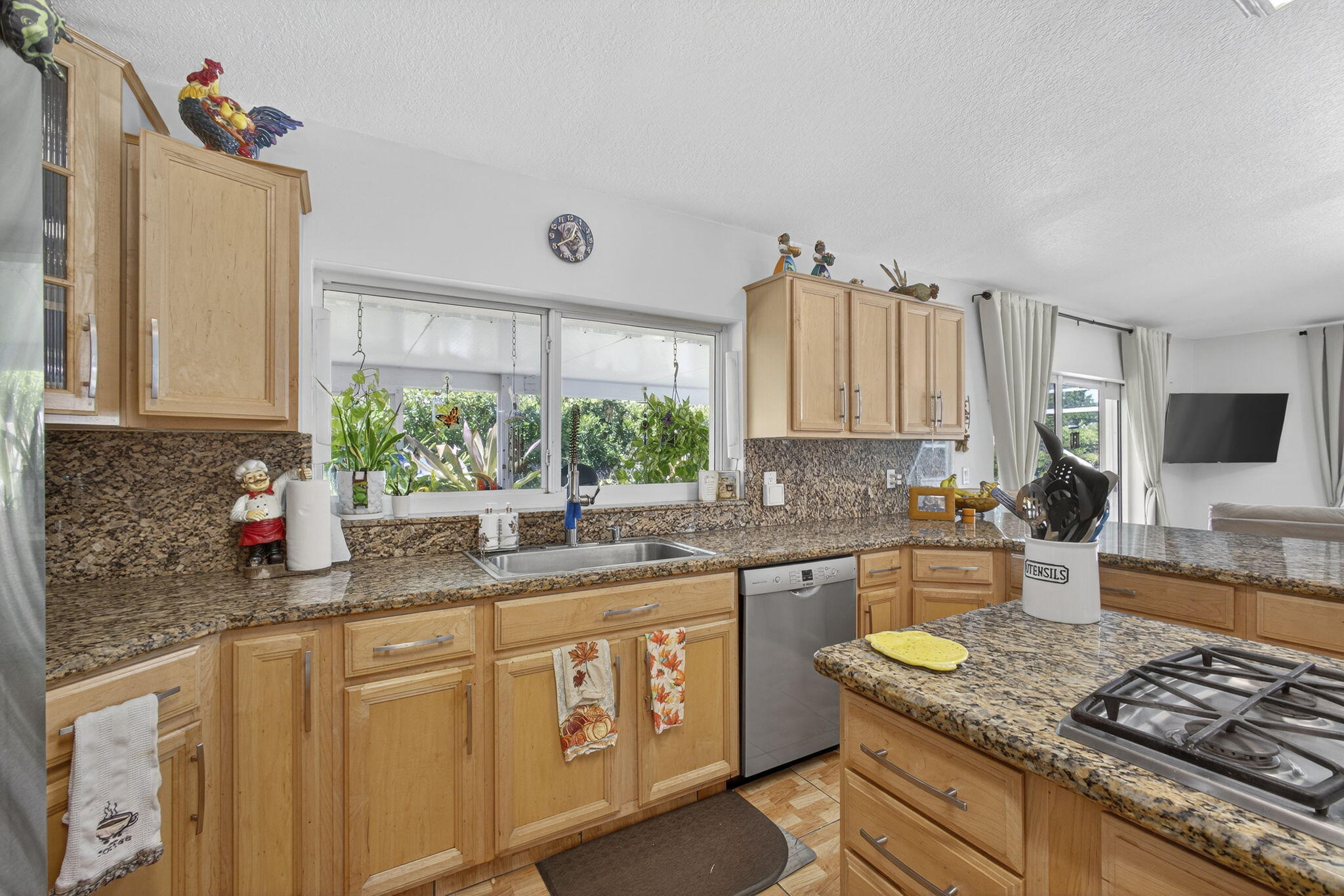 7625 Clarke Road Lake Clarke Shores, FL 33406 - Photo 30 of 97 a kitchen with stainless steel appliances granite countertop a sink stove and cabinets