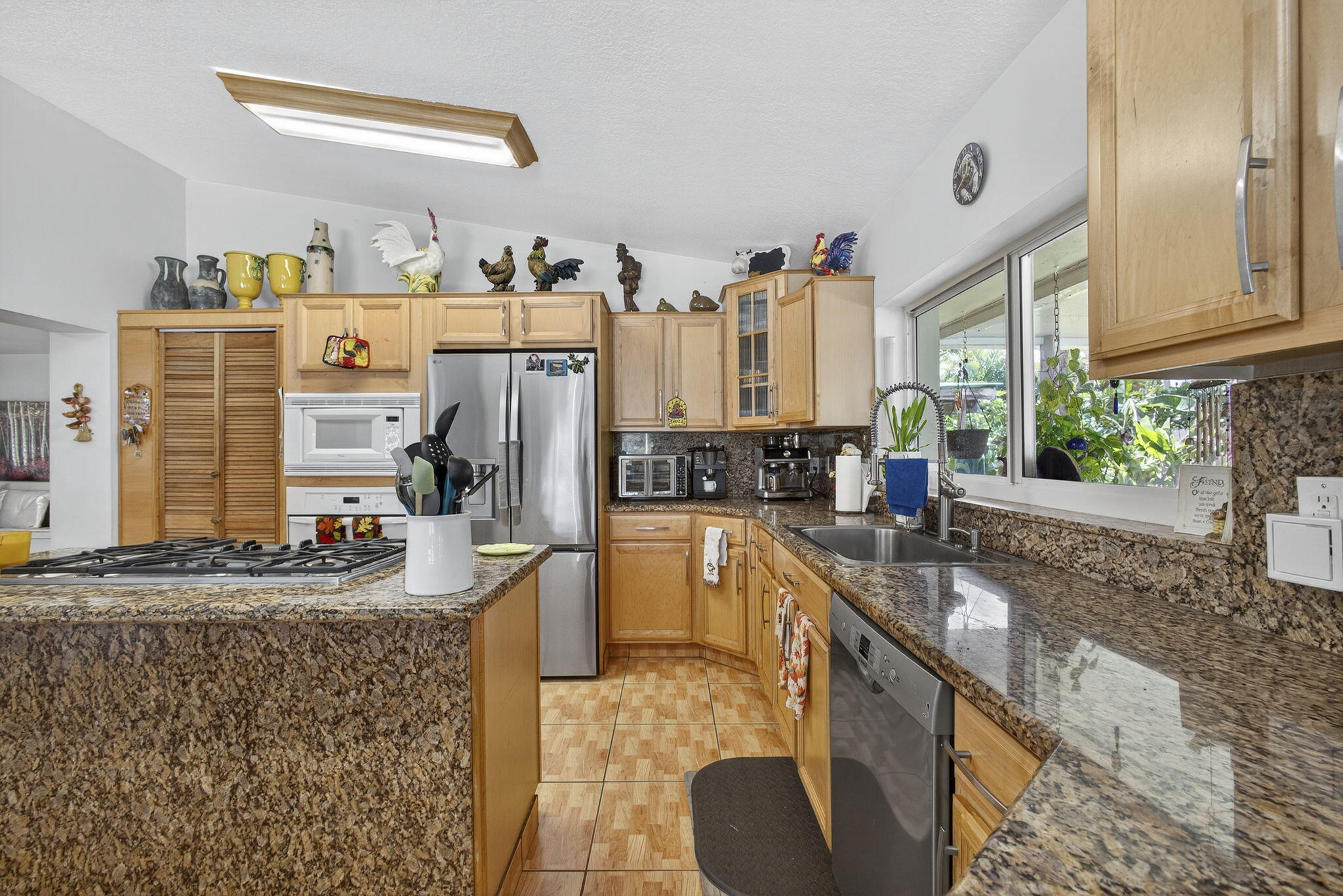 7625 Clarke Road Lake Clarke Shores, FL 33406 - Photo 32 of 97 a kitchen with stainless steel appliances granite countertop a sink stove and refrigerator