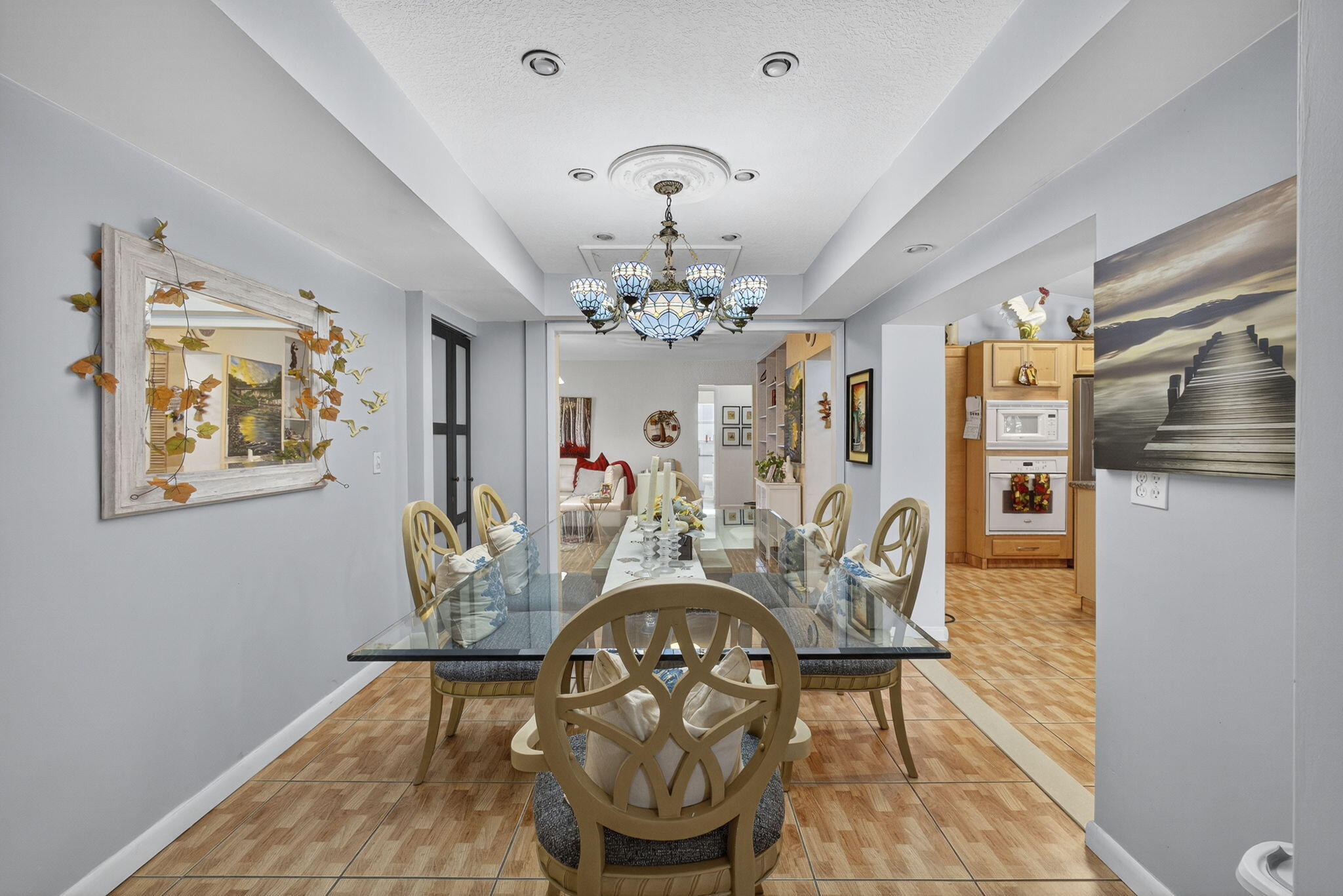 7625 Clarke Road Lake Clarke Shores, FL 33406 - Photo 35 of 97 a view of a dining room with furniture a chandelier and wooden floor