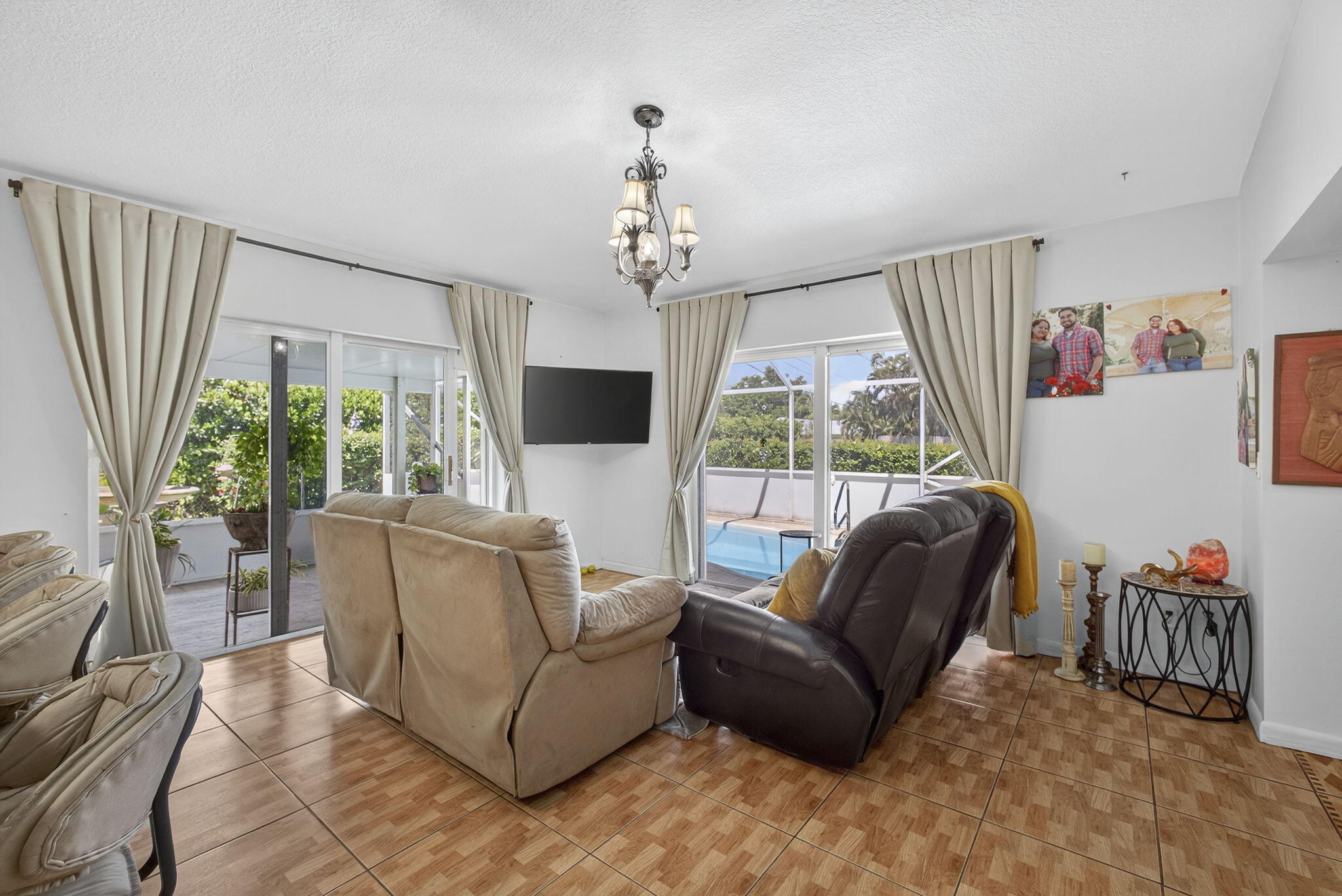 7625 Clarke Road Lake Clarke Shores, FL 33406 - Photo 38 of 97 a living room with furniture a flat screen tv and a large window