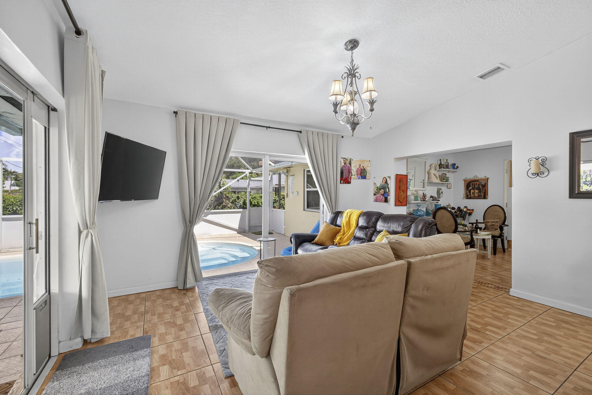 7625 Clarke Road Lake Clarke Shores, FL 33406 - Photo 41 of 97 a living room with furniture a flat screen tv and a chandelier