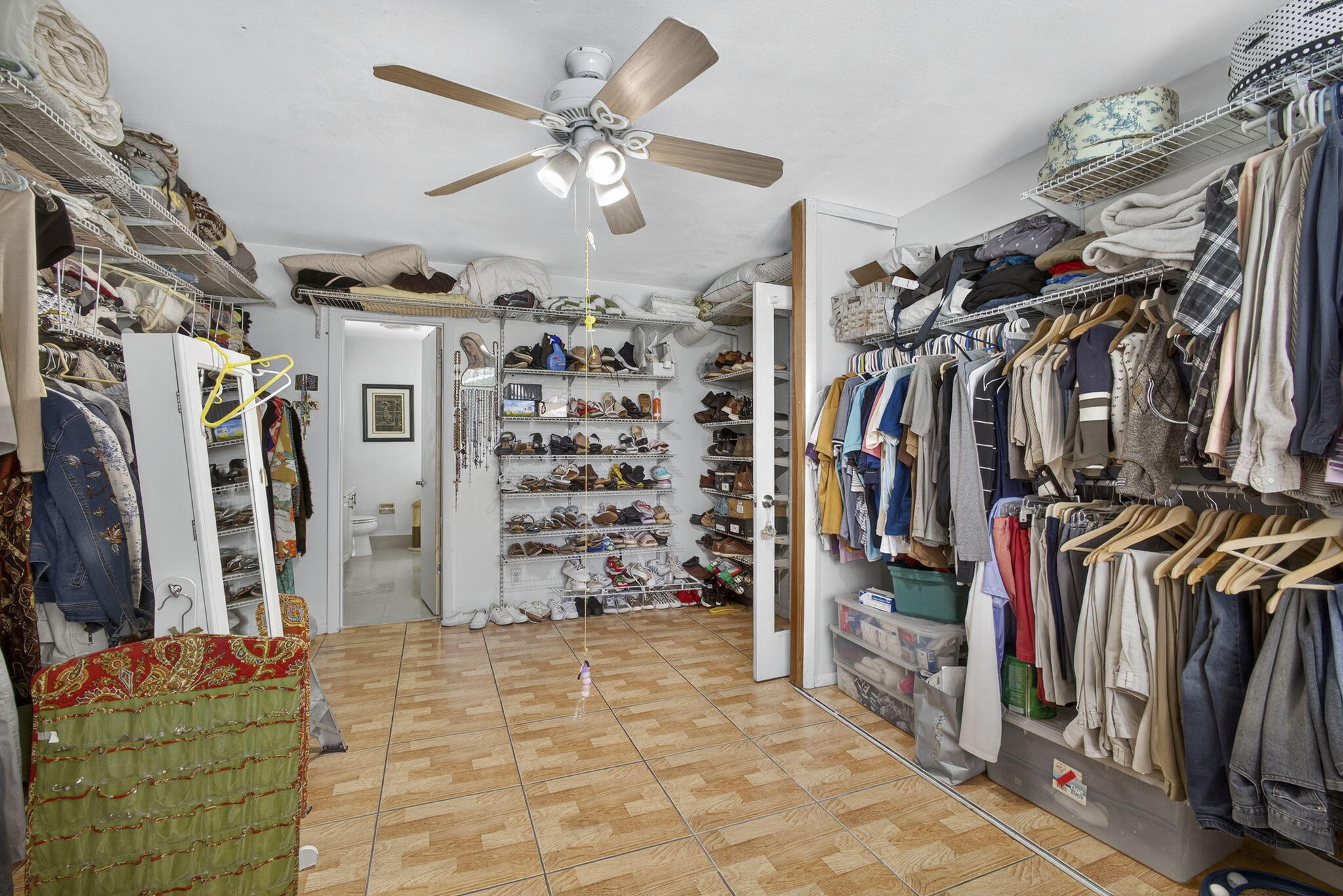 7625 Clarke Road Lake Clarke Shores, FL 33406 - Photo 50 of 97 a view of walk in closet with clothes and shoes