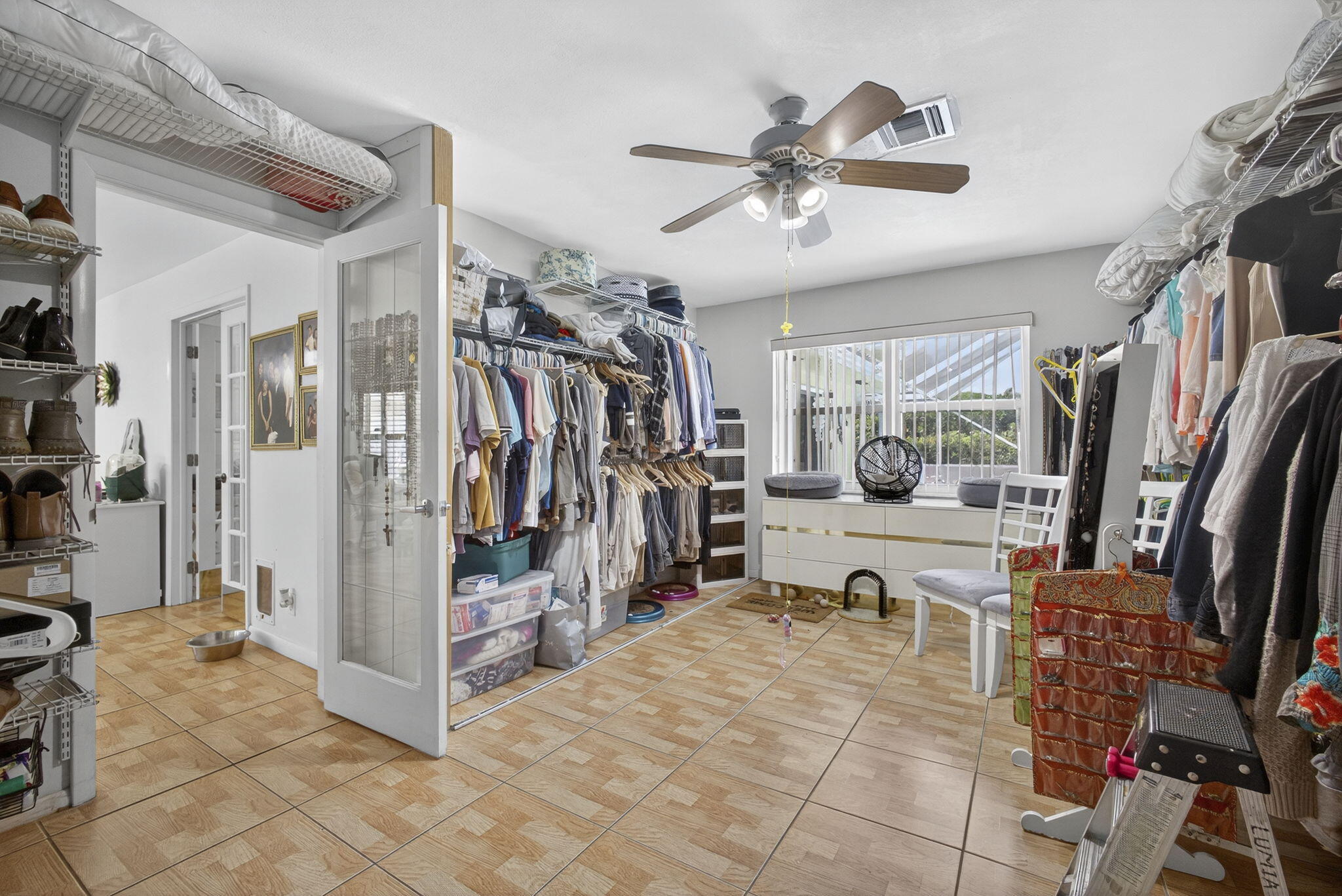 7625 Clarke Road Lake Clarke Shores, FL 33406 - Photo 55 of 97 a view of a livingroom with a dinning area hardwood floor and a ceiling fan