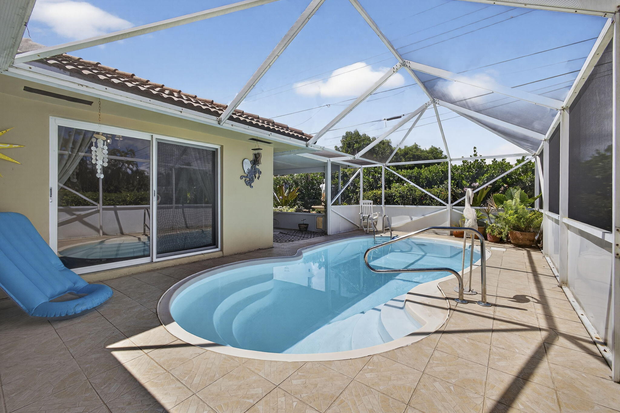 7625 Clarke Road Lake Clarke Shores, FL 33406 - Photo 63 of 97 a view of a patio with table and chairs with wooden floor and plants