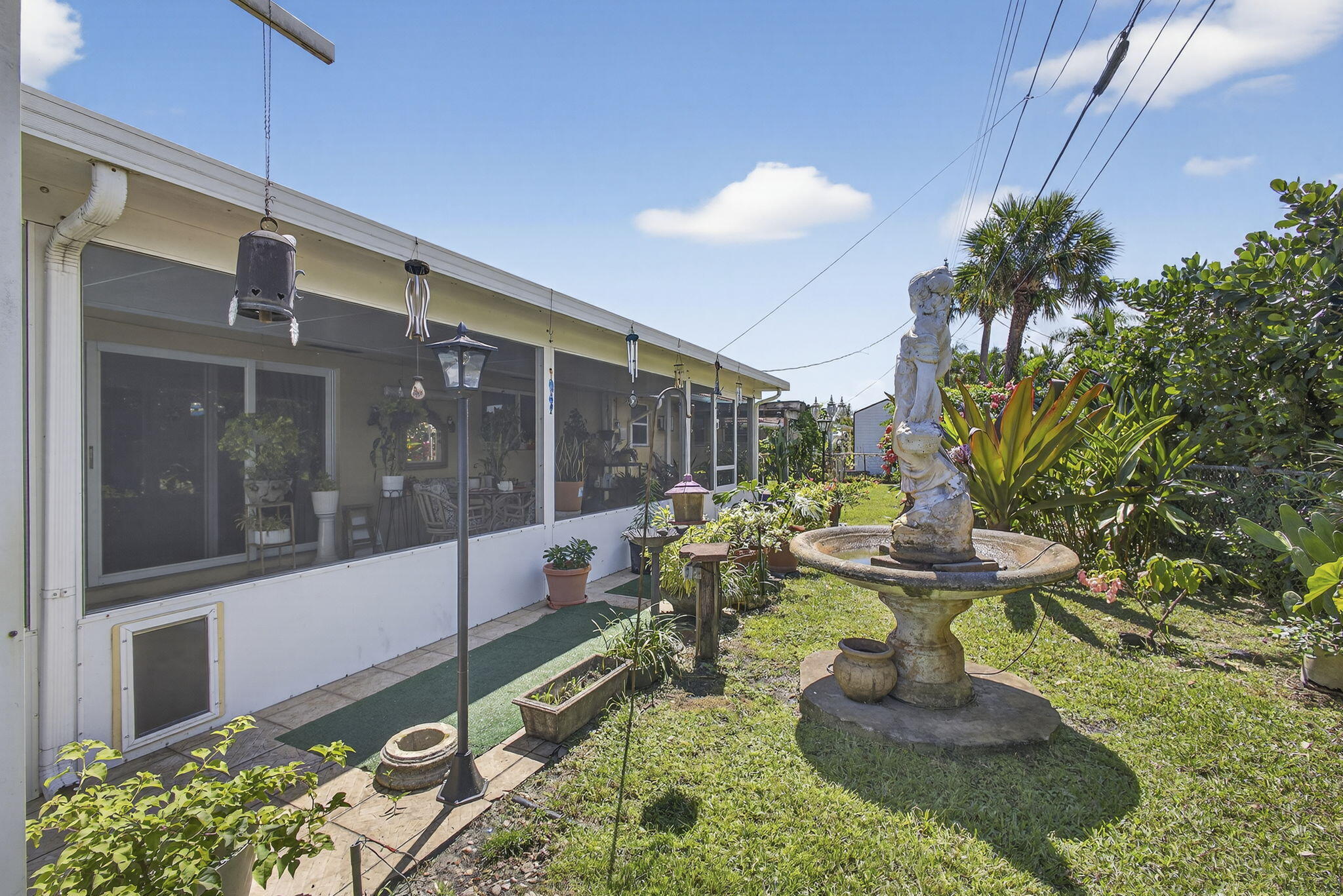 7625 Clarke Road Lake Clarke Shores, FL 33406 - Photo 68 of 97 a view of a porch with chairs and a potted plant