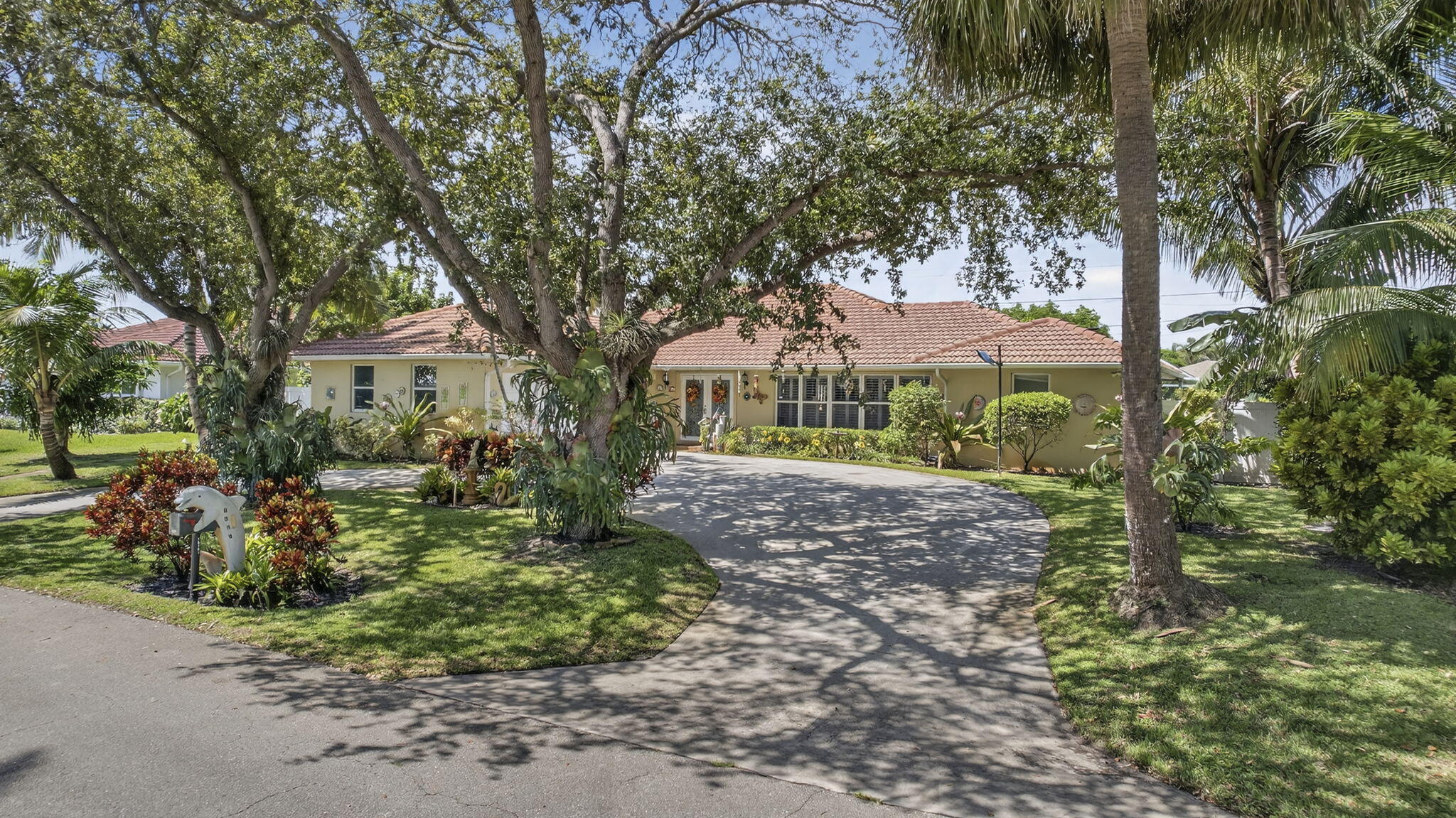 7625 Clarke Road Lake Clarke Shores, FL 33406 - Photo 80 of 97 a front view of a house with garden