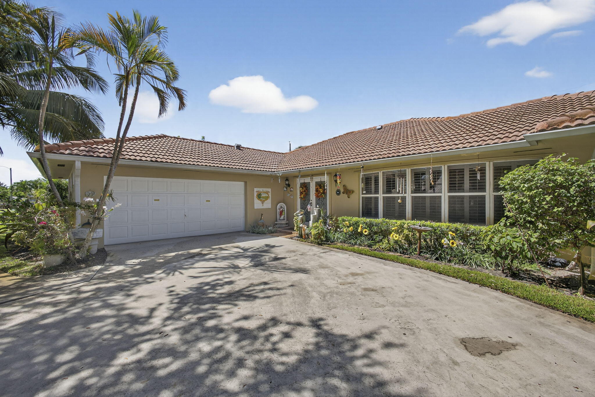 7625 Clarke Road Lake Clarke Shores, FL 33406 - Photo 8 of 97 a view of a house with a yard and potted plants