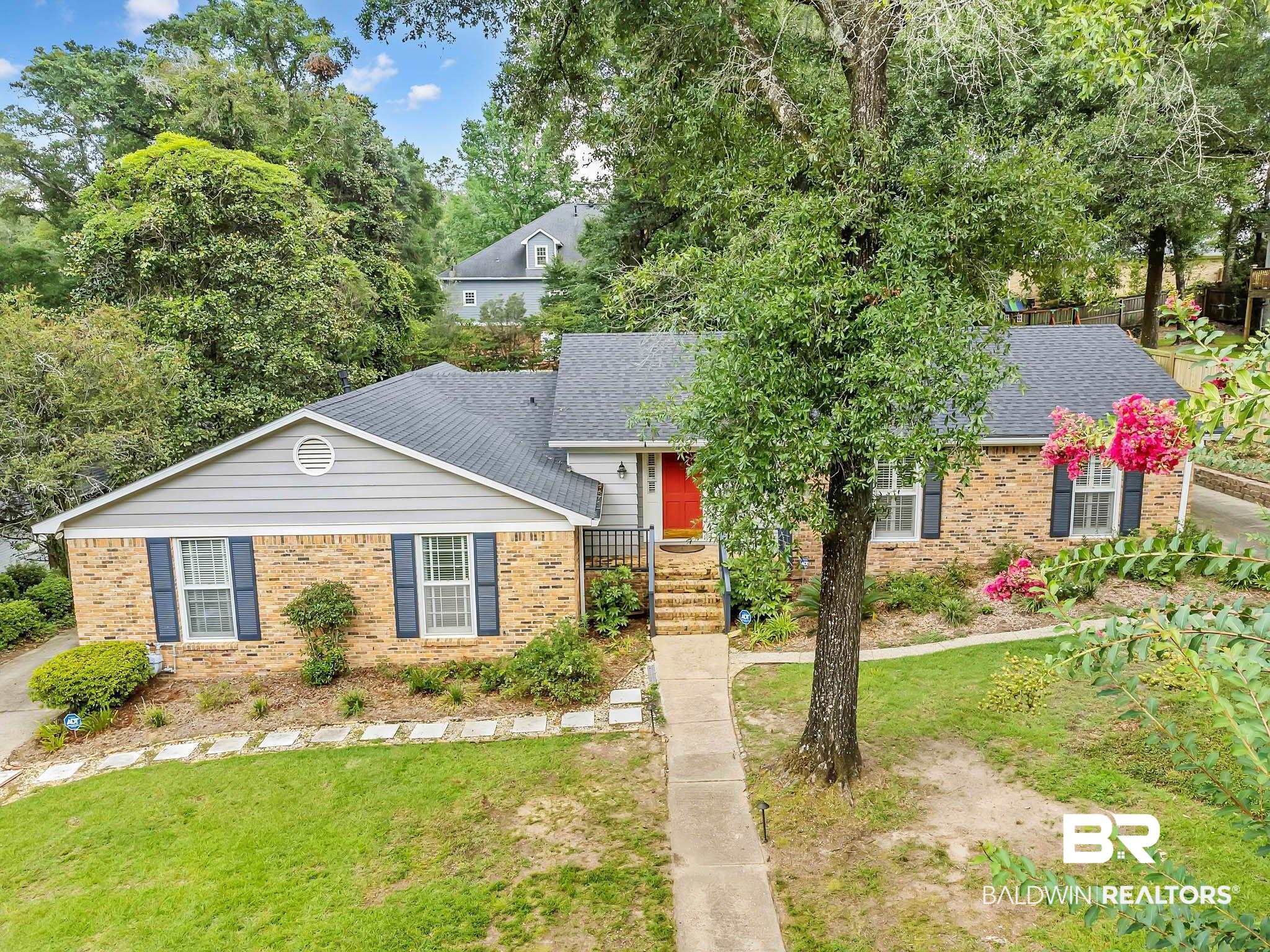 309 West Brandy Run Road Mobile, AL 36608 - Photo 91 of 100 View of front of home with brick siding, a shingled roof, a front yard, and view of wooded area